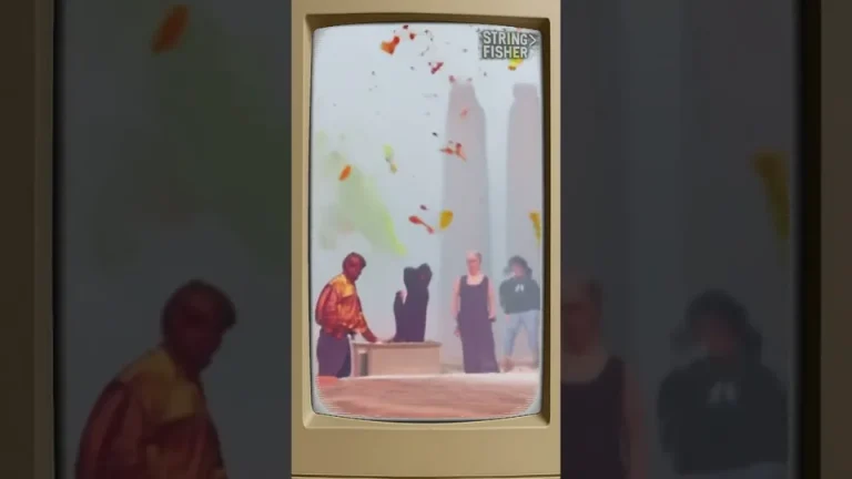 March to the Start video thumbnail: a beige monitor showing figures beneath falling coloured shapes.